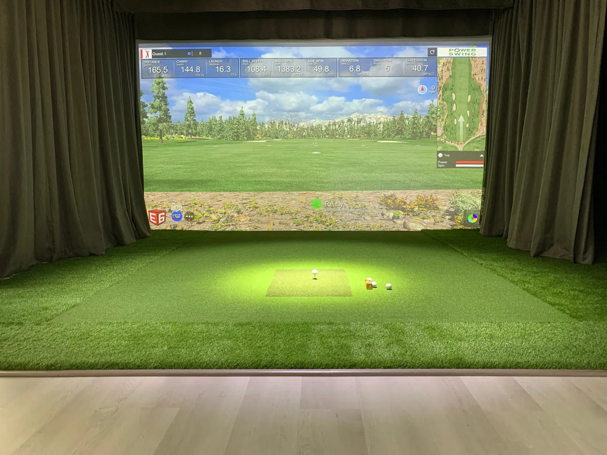 Power Swing simulator displaying measured shot data in an indoor golf bay